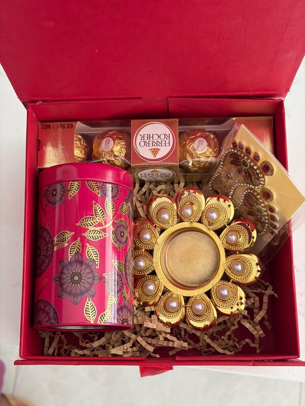 Open box with almond jar, pearl diya and Ferrero Rocher