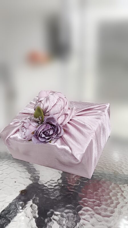 Pink satin wrapped hamper with mauve flowers